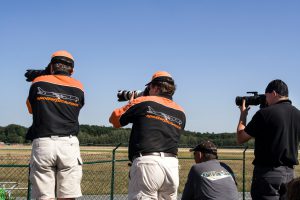 Frankfurt, Germany - August 15, 2009: Aircraft spotters at Frankfurt airport, Startbahn West, observing planes during take-off. Aircraft spotters observe, log and photograph departing and arrival planes. At Frankfurt airport the Airport authorities set up a special observation point in order to allow the photographers and spotters a perfect view.